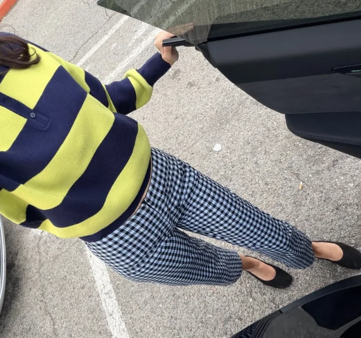 Stripes meet checks. Broad stripes and small checks aren't trying to match. Dark blue gives them common ground; black flats bring the volume down at exactly the right moment.